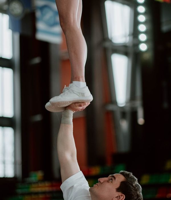 Man performing a dynamic strength exercise in a minimalist gym.